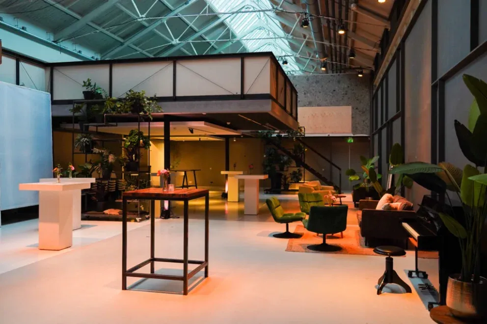 Studio 2 at De Hallen Studio's: brick, steel, daylight from the roof, plants and warm lamps